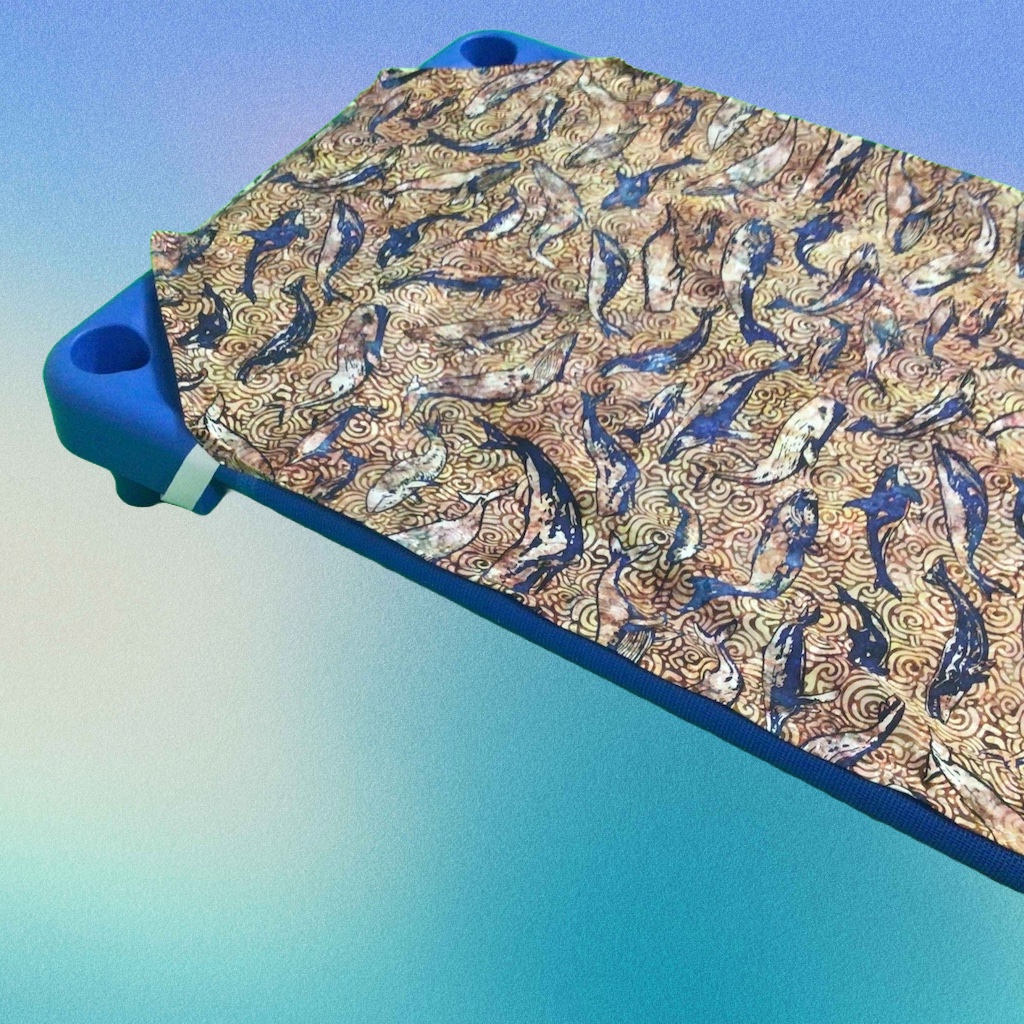 Whales cot sheet on a universal cot